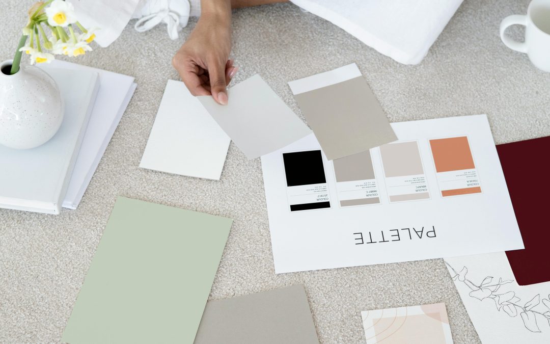 Person sitting on floor with color swatches and notebooks planning next steps to overcome fear of failure